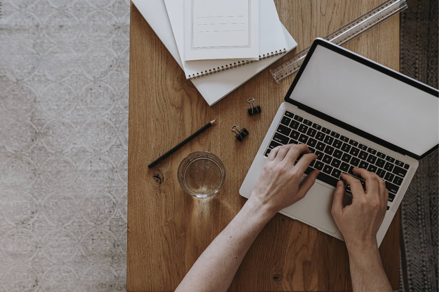 A laptop with tax papers and a cup of tea.